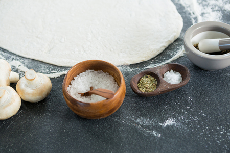 Close-up of pizza dough with various ingredientsの写真素材