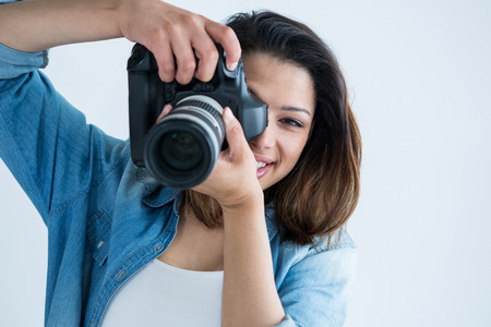 Female photographer with digital camera in studio