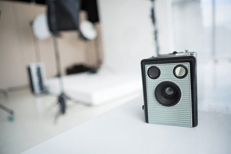 Close-up of old fashioned camera on table in studioの写真素材