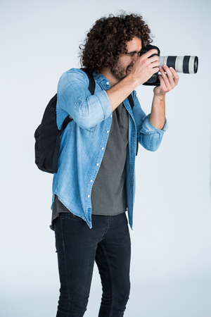 Male photographer with digital camera in studioの写真素材