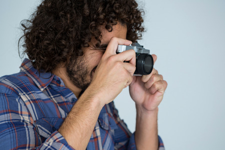 Male photographer with old fashioned camera in studioの写真素材