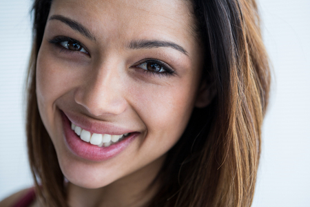 Close-up of happy female photographer in studioの写真素材