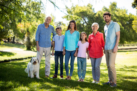 Portrait of happy family enjoying in park on sunny a day