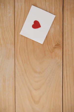 Heart printed envelope against wooden backgroundの写真素材