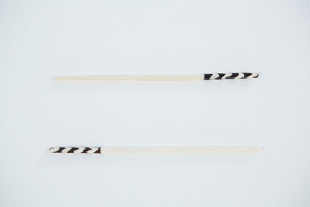 Close-up of chopsticks on white backgroundの写真素材