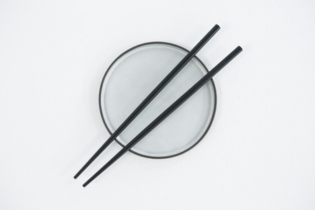 Chopsticks with bowl on white backgroundの写真素材