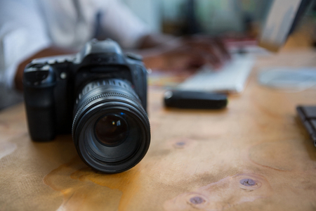 Close-up of digital camera on office desk