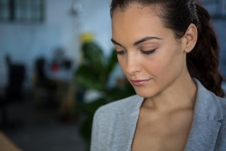 Close-up of beautiful businesswoman in officeの写真素材