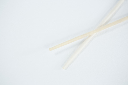 Chopsticks on a chopstick rest against white backgroundの写真素材