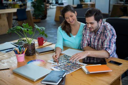 Graphic designers working at desk in office
