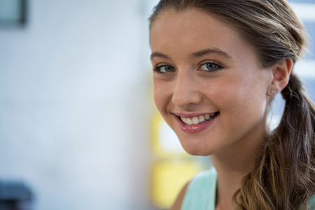 Portrait of business executive smiling at camera in officeの写真素材