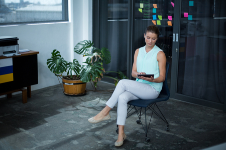 Graphic designer using laptop at his desk in officeの写真素材