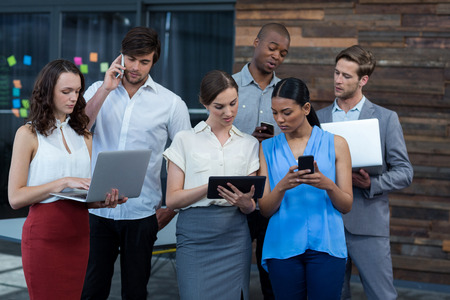 Attentive business executives working in officeの写真素材