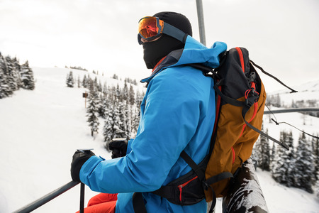 Side view of skier looking at beautiful snow-covered mountains