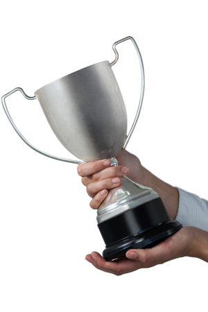 Females hands holding trophy against white backgroundの写真素材
