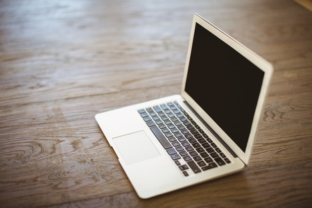 Laptop on wooden floor at homeの写真素材