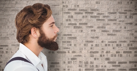 Digital composite of Man with beard against brick wall
