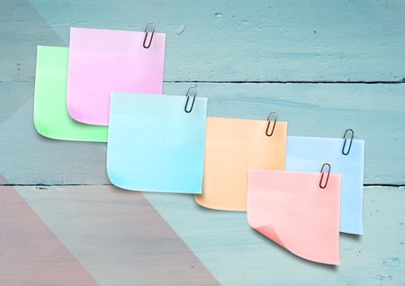 Digital composite of Sticky Note against a colourfull wood backgroundの写真素材