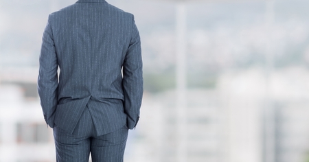 Digital composite of Businessman back against windowsの写真素材