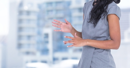 Digital composite of Businesswoman Torso against buildingsの写真素材