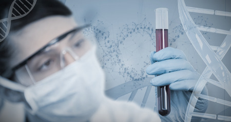 Female scientist conducting an experiment against device screen of dna helix pattern