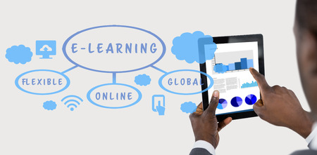 Cropped image of businessman using digital tablet against grey backgroundの写真素材