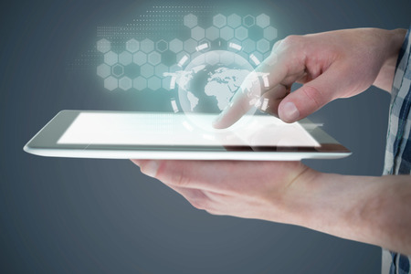 Cropped image of man using digital tablet against black