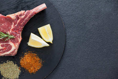 Blade chop, spices and lemon on black round tray against black backgroundの写真素材