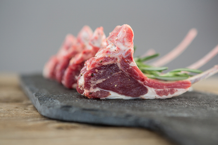 Close-up of Rib chops and rosemary herb on slate boardの写真素材