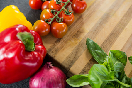 Close-up of wooden and vegetables against black backgroundの写真素材