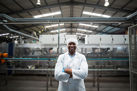 Portrait of factory engineer standing with his arms crossed in drinks production plant
