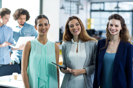 Portrait of smiling business executives at meeting in officeの写真素材