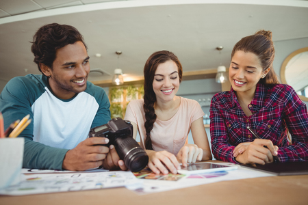 Fashion designers using digital tablet in officeの写真素材