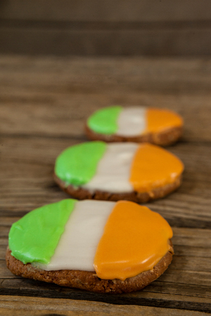 St. Patricks Day three cookies with irish flag toppings on wooden backgroundの写真素材
