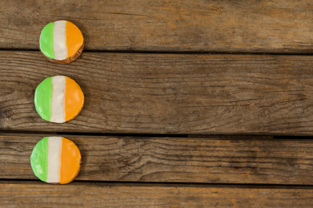 St. Patricks Day three cookies with irish flag toppings on wooden backgroundの写真素材