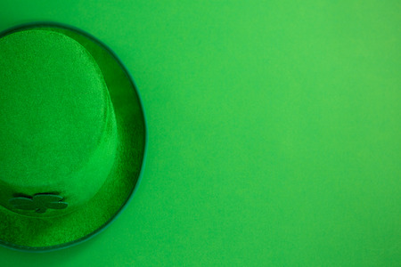 St Patricks Day leprechaun hat with shamrock on green backgroundの写真素材