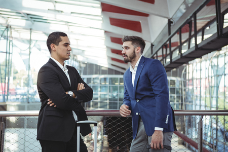 Attentive executives interacting with each other on platformの写真素材