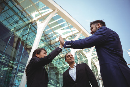 Businesses executives giving high five to each other outside platformの写真素材