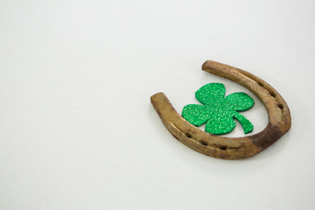 St Patricks Day shamrock with horseshoe on white backgroundの写真素材