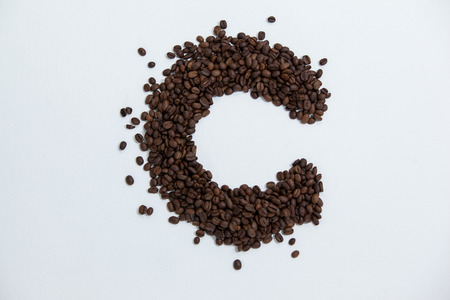 Coffee beans forming alphabet C on white backgroundの写真素材