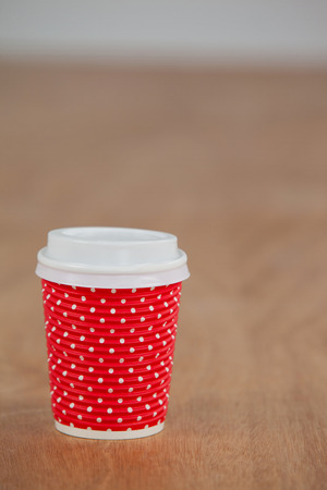 Take away disposable coffee cup on wooden backgroundの写真素材