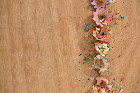 Close-up of colored pencil shavings on wooden backgroundの写真素材