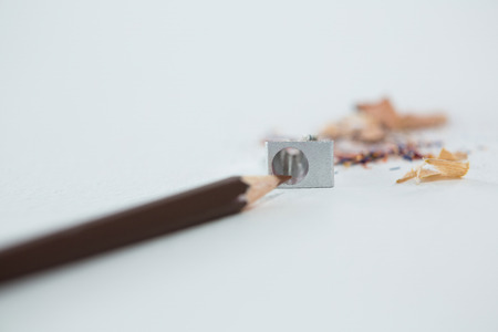 Colored shavings with brown color pencil on white backgroundの写真素材