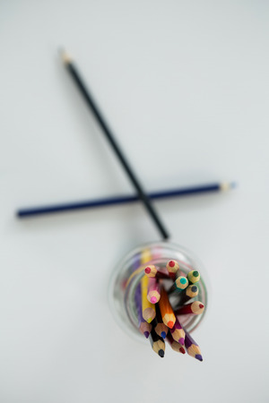 Colored pencils kept in jar on white backgroundの写真素材