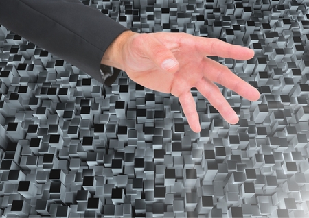 Digital composite of open Hand against small cubes