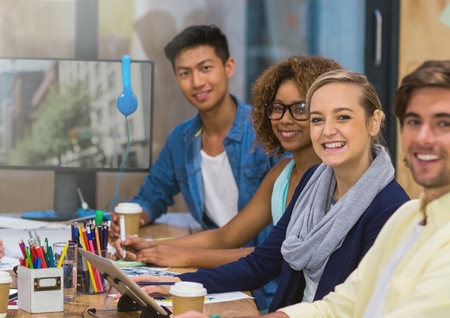 Digital composite of Team Worker smiling at camera against a office background