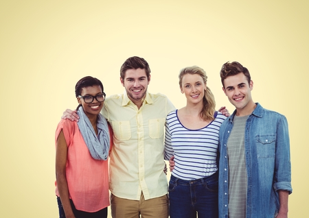 Digital composite of Happy group of young people smiling at camera against a yellow background