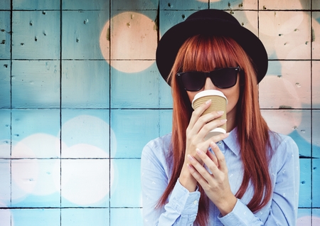 Digital composite of Woman with coffee against tiles with bokehの写真素材