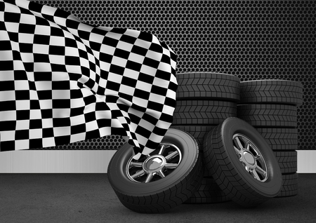 Composite image of stack of tires with checkered flag against black backgroundの写真素材