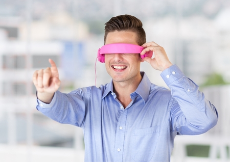 Digital composition of man using virtual reality glasses against office window in background